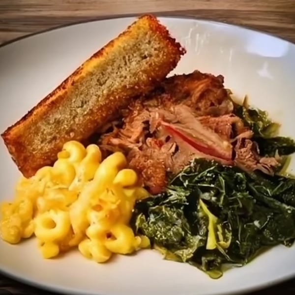 FATBOYSBBQ plate with pulled pork, mac and cheese, collard greens, and cornbread.